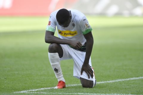 Moenchengladbach's Marcus Thuram reacts after scoring his side's second goal during the German Bundesliga soccer match between Borussia Moenchengladbach and Union Berlin in Moenchengladbach, Germany, Sunday, May 31, 2020. The German Bundesliga becomes the world's first major soccer league to resume after a two-month suspension because of the coronavirus pandemic. (AP Photo/Martin Meissner, Pool)