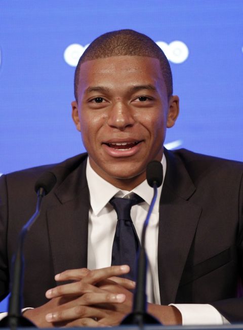 French soccer player Kylian Mbappe attends a press conference in Paris, Wednesday, Sept. 6, 2017. Mbappe is a young man in a big hurry and wants to "win everything" with his new club Paris Saint-Germain. (AP Photo/Christophe Ena)