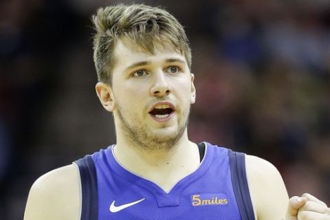 Dallas Mavericks forward Luka Doncic reacts after a basket by teammate Justin Jackson pulled the Mavericks within nine points during the second half of an NBA basketball game against the Houston Rockets, Monday, Feb. 11, 2019, in Houston. Houston won 120-104. (AP Photo/Eric Christian Smith)