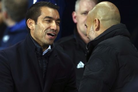 Feyenoord coach Giovanni Van Bronckhorst, left, shakes hands with Manchester City coach Josep Guardiola prior to the start of the Champions League group F soccer match between Manchester City and Feyenoord, at the Etihad Stadium in Manchester, England, Tuesday, Nov. 21, 2017. (AP Photo/Dave Thompson)