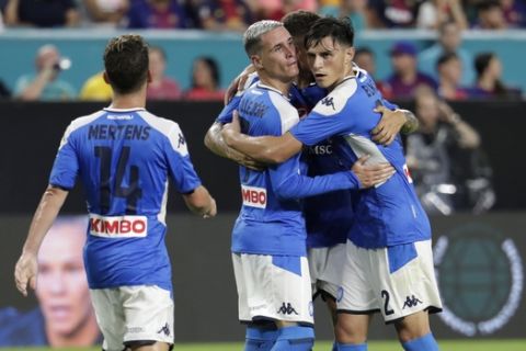 Napoli's Jose Callejon, center, celebrates with his teammates after FC Barcelona's Samuel Umtiti scored an own goal during the first half of a soccer match Wednesday, Aug. 7, 2019, in Miami Gardens, Fla. (AP Photo/Lynne Sladky)