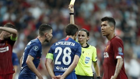 Referee Stephanie Frappart shows a yellow card to Chelsea's Cesar Azpilicueta during the UEFA Super Cup soccer match between Liverpool and Chelsea, in Besiktas Park, in Istanbul, Wednesday, Aug. 14, 2019. (AP Photo/Thanassis Stavrakis)