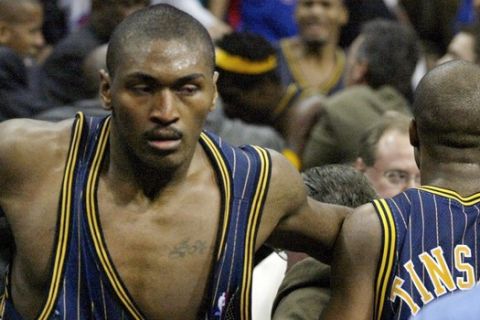 FILE - In this Nov. 19, 2004, file photo, Indiana Pacers forward Ron Artest gets back on the court after going into the stands after fans during a brawl with the Detroit Pistons with just 45.9 seconds left in an NBA basketball game in Auburn Hills, Mich. Artest was suspended for 72 games, the longest Commissioner David Stern ever handed out for an on-court punishment. He is not in the Hall of Fame, he never played in an All-Star game and he is about a foot shorter than most NBA stars. But try to find an NBA legacy more lasting than Stern's, who is retiring Saturday, Feb. 1, 2014 after exactly 30 years on the job. (AP Photo/Duane Burleson, File)