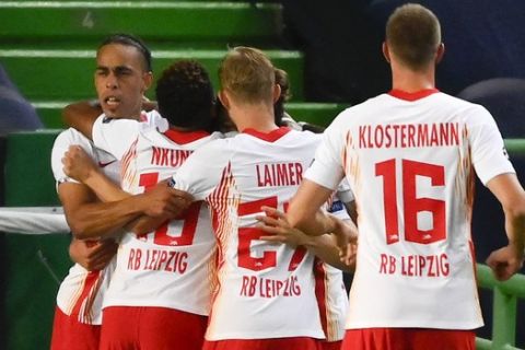 RB Leipzig players celebrate their first goal during the Champions League quarterfinal match between RB Leipzig and Atletico Madrid at the Jose Alvalade stadium in Lisbon, Portugal, Thursday, Aug. 13, 2020. (Lluis Gene/Pool Photo via AP)