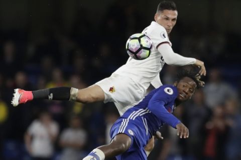 Chelsea's Michy Batshuayi, right, vies for the ball with Watford's Jose Holebas during the English Premier League soccer match between Chelsea and Watford at Stamford Bridge stadium in London, Monday, May 15, 2017. (AP Photo/Matt Dunham)