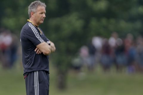 AC Milan coach Sinisa Mihajlovic stands on the pitch during a training session at the Milanello center in Carnago, near Milan, Italy, Friday, July 3, 2015. AC Milan president Silvio Berlusconi has demanded new coach Sinisa Mihajlovic lead the club back into the Champions League. (AP Photo/Luca Bruno)