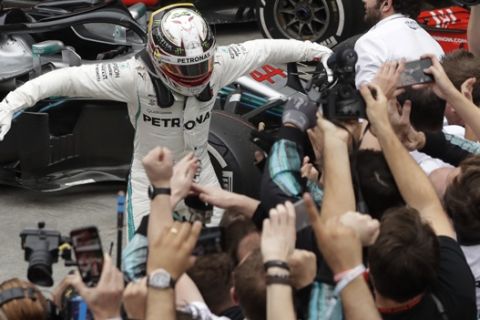 Mercedes driver Lewis Hamilton, of Britain, celebrates with teammates after winning the Brazilian Formula One Grand Prix at the Interlagos race track in Sao Paulo, Brazil, Sunday, Nov. 11, 2018. (AP Photo/Andre Penner)