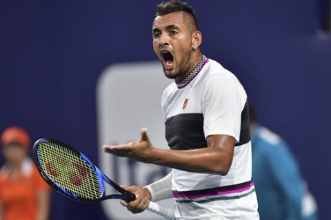 Nick Kyrgios, of Australia, yells during his match against Dusan Lajovic, of Serbia, during the third round of the Miami Open tennis tournament, Sunday, March 24, 2019, in Miami Gardens, Fla. (AP Photo/Jim Rassol)