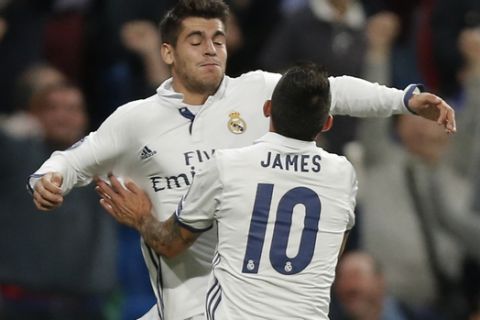 Real Madrid's James Rodriguez, front, hugs Real Madrid's Alvaro Morata who scored 2-1 during a Champions League, Group F soccer match between Real Madrid and Sporting, at the Santiago Bernabeu stadium in Madrid, Spain, Wednesday, Sept. 14, 2016. (AP Photo/Daniel Ochoa de Olza)