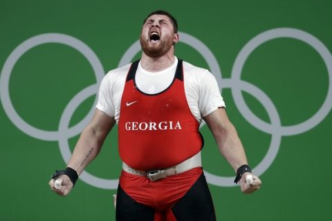Lasha Talakhadze, of Georgia, celebrates after a lift in the men's +105 kg weightlifting event at the 2016 Summer Olympics in Rio de Janeiro, Brazil, Tuesday, Aug. 16, 2016. Talakhadze won the gold medal. (AP Photo/Mike Groll)