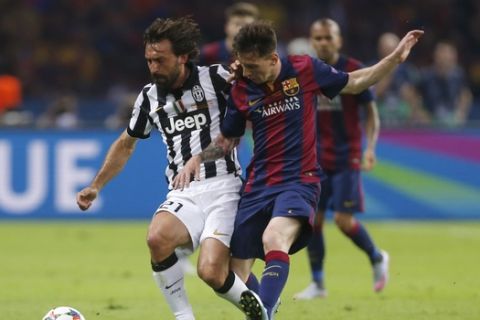 Juventus' Andrea Pirlo, left, is challenged by Barcelona's Lionel Messi during the Champions League final soccer match between Juventus Turin and FC Barcelona at the Olympic stadium in Berlin Saturday, June 6, 2015. (AP Photo/Frank Augstein)