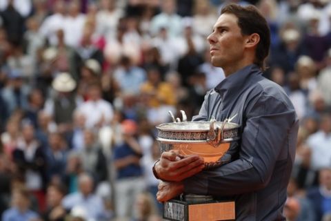 FILE - In this June 9, 2019, file photo, Spain's Rafael Nadal celebrates his record 12th French Open tennis tournament title after winning the men's final against Austria's Dominic Thiem at Roland Garros stadium in Paris. If not for the coronavirus pandemic, the second week of the French Open this week would have had fourth-round matches, quarterfinals, semifinals and the final for men and women. Nadal could have been trying to add to his 12 trophies at Roland Garros. (AP Photo/Christophe Ena, File)