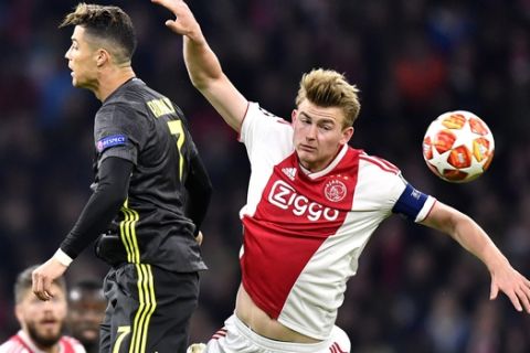 Juventus' Cristiano Ronaldo, left, and Ajax's Matthijs de Ligt jump for the ball during the Champions League quarterfinal, first leg, soccer match between Ajax and Juventus at the Johan Cruyff ArenA in Amsterdam, Netherlands, Wednesday, April 10, 2019. (AP Photo/Martin Meissner)