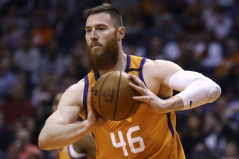 Phoenix Suns center Aron Baynes grabs a rebound against the Portland Trail Blazers during the first half of an NBA basketball game Friday, March 6, 2020, in Phoenix. The Suns defeated the Trail Blazers 127-117. (AP Photo/Ross D. Franklin)