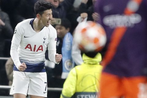 Tottenham's Son Heung-min, left, celebrates after scoring during the Champions League, round of 8, first-leg soccer match between Tottenham Hotspur and Manchester City at the Tottenham Hotspur stadium in London, Tuesday, April 9, 2019. (AP Photo/Frank Augstein)