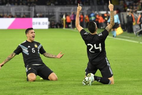 Argentina's Lucas Ocampos, right, celebrates after scoring his side's second goal during the international friendly soccer match between Germany and Argentina at the Signal Iduna Park stadium in Dortmund, Germany, Wednesday, Oct. 9, 2019. (AP Photo/Martin Meissner)