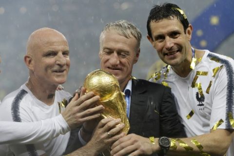 France head coach Didier Deschamps, second right, holds the trophy at the end of the final match between France and Croatia at the 2018 soccer World Cup in the Luzhniki Stadium in Moscow, Russia, Sunday, July 15, 2018. (AP Photo/Matthias Schrader)