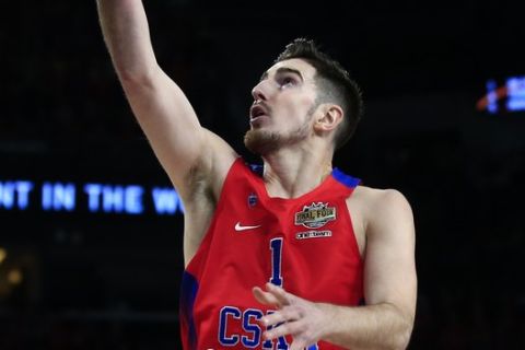 CSKA's Moscow Nando De Colo jumps to score as Olympiakos' players look on during their Final Four Euroleague semifinal basketball match at Sinan Erdem Dome in Istanbul, Friday, May 19, 2017. (AP Photo/Lefteris Pitarakis)