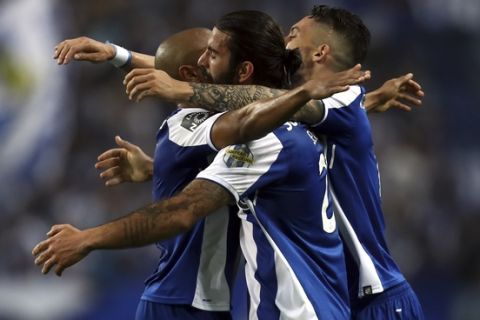 Porto's Sergio Oliveira, center, celebrates after scoring the opening goal during the Portuguese league soccer match between FC Porto and Feirense at the Dragao stadium in Porto, Portugal, Sunday, May 6, 2018. Porto clinched the league title Saturday night, two rounds before the end, when Benfica and Sporting CP tied 0-0 in their Lisbon derby. (AP Photo/Luis Vieira)