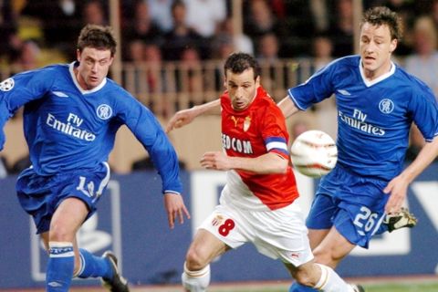 Monaco's captain Ludovic Giuly, center, slips through John Terry, right, and Wayne Bridge of Chelsea during their Champions League first leg semifinal match in Monaco, Tuesday, April 20, 2004. (AP Photo/Claude Paris)
