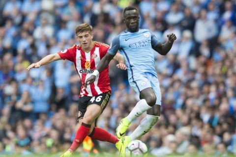 Manchester City's Bacary Sagna, right, fights for the ball against Sunderland's Lynden Gooch during the English Premier League soccer match between Manchester City and Sunderland at the Etihad Stadium in Manchester, England, Saturday Aug. 13, 2016. (AP Photo/Jon Super)  