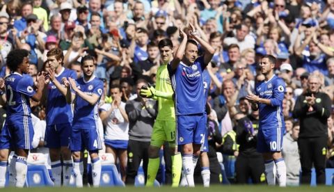 Chelsea's team captain John Terry, center, is applauded as he leaves the pitch after being substituted during the English Premier League soccer match between Chelsea and Sunderland at Stamford Bridge stadium in London, Sunday, May 21, 2017. (AP Photo/Kirsty Wigglesworth)