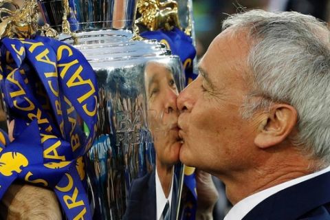 Leicester manager Claudio Ranieri kisses the trophy in celebration of his team's remarkable English Premier League triumph. Photo: Matt Dunham