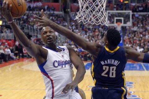 Los Angeles Clippers forward Lamar Odom, left, puts up a shot as Indiana Pacers center Ian Mahinmi, of France, defends during the first half of their NBA basketball game, Monday, April 1, 2013, in Los Angeles. (AP Photo/Mark J. Terrill)