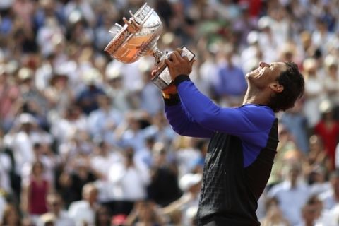Spain's Rafael Nadal lifts the cup after defeating Switzerland's Stan Wawrinka in their final match of the French Open tennis tournament at the Roland Garros stadium, Sunday, June 11, 2017 in Paris. Nadal has won his record 10th French Open title, beating No. 3 Stan Wawrinka in straight sets. (AP Photo/David Vincent)