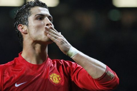 Manchester United's Cristiano Ronaldo celebrates after scoring against Sporting Lisbon during their Champion's League Group F soccer match at Old Trafford Stadium, Manchester, England, Tuesday Nov. 27, 2007. (AP Photo/Jon Super)