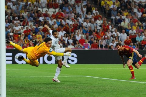 DONETSK, UKRAINE - JUNE 23:  Xabi Alonso of Spain scores the first goal past Hugo Lloris of France during the UEFA EURO 2012 quarter final match between Spain and France at Donbass Arena on June 23, 2012 in Donetsk, Ukraine.  (Photo by Laurence Griffiths/Getty Images)
