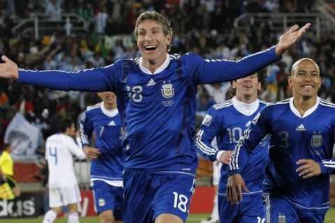 Argentina's Martin Palermo celebrates scoring his side's second goal with Argentina's Clemente Rodriguez, right, and Argentina's Lionel Messi, center, during the World Cup group B soccer match between Greece and Argentina at Peter Mokaba Stadium in Polokwane, South Africa, Tuesday, June 22, 2010.  (AP Photo/Eugene Hoshiko)