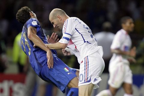 PICTURES OF THE YEAR 2006
Italy's Marco Materazzi falls on the pitch after being head-butted by France's Zinedine Zidane (R) during their World Cup 2006 final soccer match in Berlin July 9, 2006. FIFA RESTRICTION - NO MOBILE USE HOLLAND OUT  Picture taken July 9, 2006. REUTERS/Peter Schols/GPD/Handout