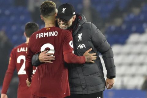 Liverpool's manager Jurgen Klopp and Liverpool's Roberto Firmino celebrate their victory at the end of the English Premier League soccer match between Leicester City and Liverpool at the King Power Stadium in Leicester, England, Thursday, Dec. 26, 2019. (AP Photo/Rui Vieira)