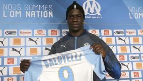 FILE - In this file photo dated Wednesday, Jan. 23, 2019, Olympique Marseille's new player Mario Balotelli poses during a press conference, at the club's headquarters of La Commanderie, in Marseille, southern France. The French club Marseille, is out of European competition after a fifth-place finish in Ligue 1, despite an attack that includes Mario Balotelli, and now Marseille must pay UEFA 2 million euros ($2.24 million) for breaking financial fair play rules, according to a UEFA announcement Wednesday June 19, 2019. (AP Photo/Claude Paris, FILE )