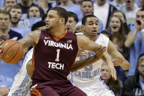 North Carolina's Marcus Paige guards Virginia Tech's Malik Muller (1) during the first half of an NCAA college basketball game in Chapel Hill, N.C., Sunday, Jan. 18, 2015. (AP Photo/Gerry Broome)