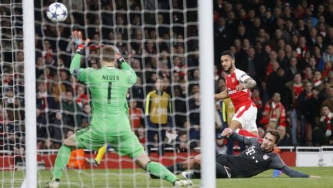 Arsenal's Theo Walcott, right, gets in a shot during the Champions League round of 16 second leg soccer match between Arsenal and Bayern Munich at the Emirates Stadium in London, Tuesday, March 7, 2017. (AP Photo/Frank Augstein)
