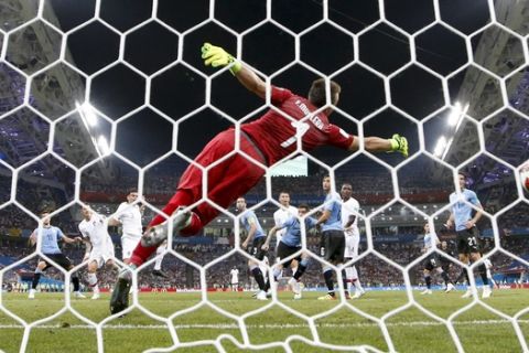 Portugal's Pepe scores his side's opening goal past Uruguay goalkeeper Fernando Muslera during the round of 16 match between Uruguay and Portugal at the 2018 soccer World Cup at the Fisht Stadium in Sochi, Russia, Saturday, June 30, 2018. (AP Photo/Andrew Medichini)