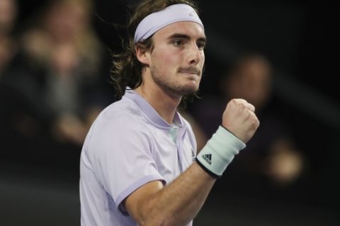 Stefanos Tsitsipas of Greece clenches his fist after scoring against Felix Auger-Aliassime of Canada in the men's singles final of the Open 13 Provence tennis tournament in Marseille, southern France, Sunday, Feb. 23, 2020. (AP Photo/Daniel Cole)