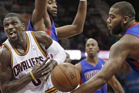 Cleveland Cavaliers' Jermaine Taylor, left, loses the ball after being fouled by Detroit Pistons' Greg Monroe (10) in the fourth quarter of a preseason NBA basketball game Thursday, Oct. 17, 2013, in Cleveland. The Cavaliers won 96-84. (AP Photo/Mark Duncan)