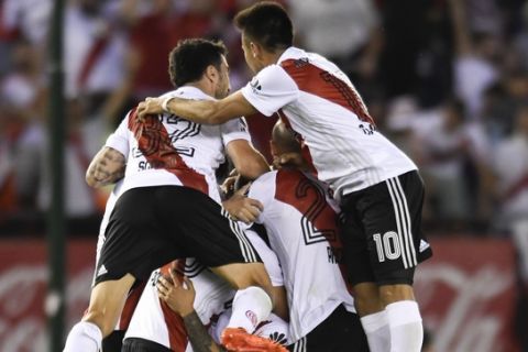 In this Sunday, Nov. 5, 2017 photo, River Plate's players celebrate scoring against Boca Juniors during local tournament soccer match in Buenos Aires, Argentina. (AP Photo/Gustavo Garello)