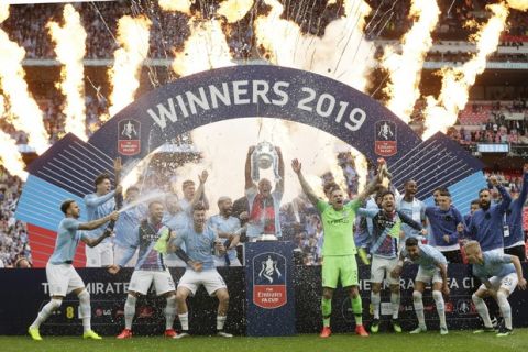 Manchester City players celebrate after winning the English FA Cup Final soccer match between Manchester City and Watford at Wembley stadium in London, Saturday, May 18, 2019. Manchester City won 6-0. (AP Photo/Tim Ireland)