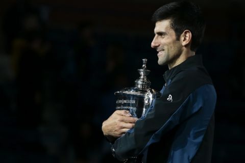 Novak Djokovic, of Serbia, holds the championship trophy after defeating Juan Martin del Potro, of Argentina, in the men's final of the U.S. Open tennis tournament, Sunday, Sept. 9, 2018, in New York. (AP Photo/Andres Kudacki)