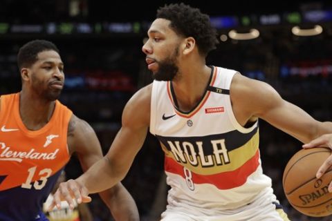 New Orleans Pelicans' Jahlil Okafor (8) drives past Cleveland Cavaliers' Tristan Thompson (13) in the second half of an NBA basketball game, Saturday, Jan. 5, 2019, in Cleveland. (AP Photo/Tony Dejak)