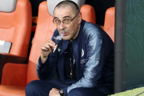 Chelsea head coach Maurizio Sarri smokes a cigaret on the bench after winning the Europa League Final soccer match between Chelsea and Arsenal at the Olympic stadium in Baku, Azerbaijan, Thursday, May 30, 2019. Chelsea won 4-1. (AP Photo/Darko Bandic)