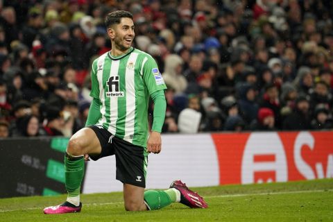 Betis' Ayoze Perez celebrates after scoring his side's opening goal during the Europa League round of 16 first leg soccer match between Manchester United and Real Betis at the Old Trafford stadium in Manchester, Thursday, March 9, 2023. (AP Photo/Dave Thompson)