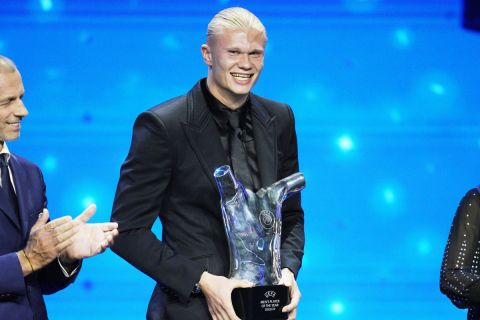 Norwegian's Erling Haaland holds the UEFA Men's Player of the Year award after the 2023/24 UEFA Champions League group stage draw at the Grimaldi Forum in Monaco, Thursday, Aug. 31, 2013. (AP Photo/Daniel Cole)