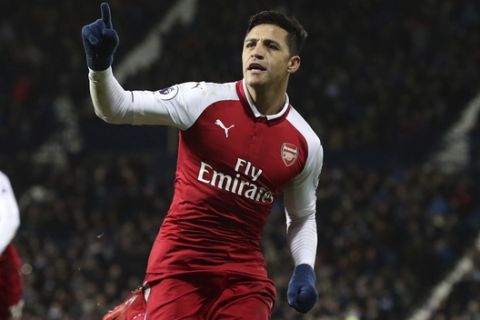 Arsenal's Alexis Sanchez celebrates scoring his side's first goal of the game, during the English Premier League soccer match between West Bromwich Albion and Arsenal, at The Hawthorns, in West Bromwich, England, Sunday, Dec. 31, 2017. (Martin Rickett/PA via AP)