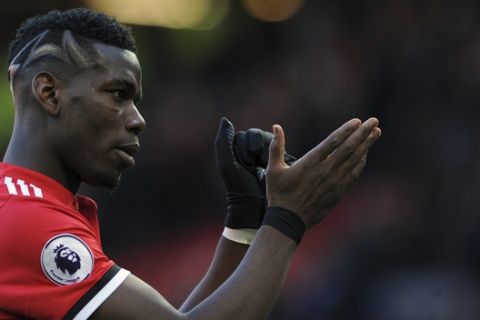 Manchester United's Paul Pogba applauds to supporters at the end of the English Premier League soccer match between Manchester United and Chelsea at the Old Trafford stadium in Manchester, England, Sunday, Feb. 25, 2018. (AP Photo/Rui Vieira)