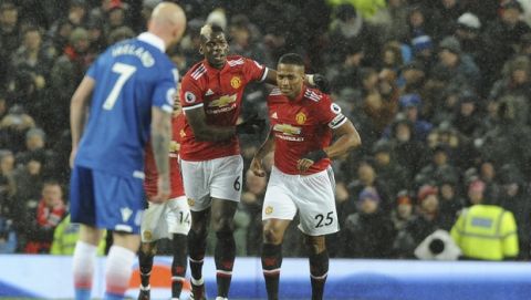 Manchester United's Antonio Valencia, right, celebrates with teammate Manchester United's Paul Pogba after scoring the opening goal go the game during the English Premier League soccer match between Manchester United and Stoke City at Old Trafford in Manchester, England, Monday, Jan. 15, 2018. (AP Photo/Rui Vieira)